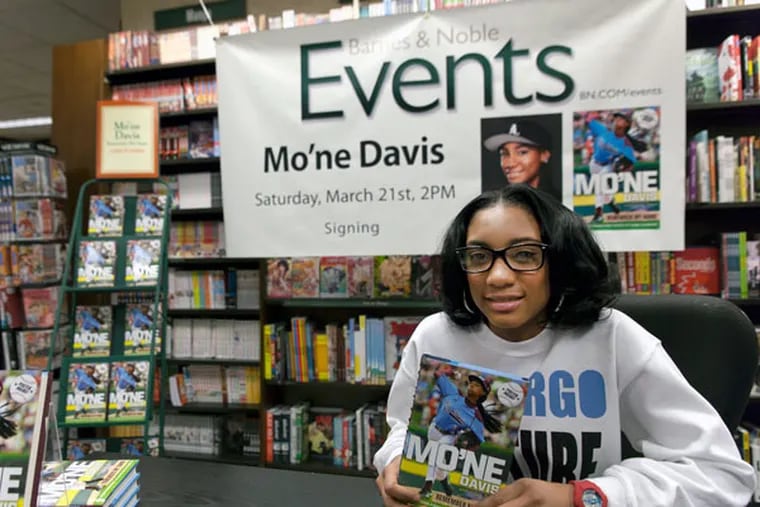 Mo'ne Davis signs copies of "Mo'ne Davis: Remember My Name" at the Barnes & Noble bookstore at 18th and Walnut Streets. (Chanda Jones / Staff Photographer)