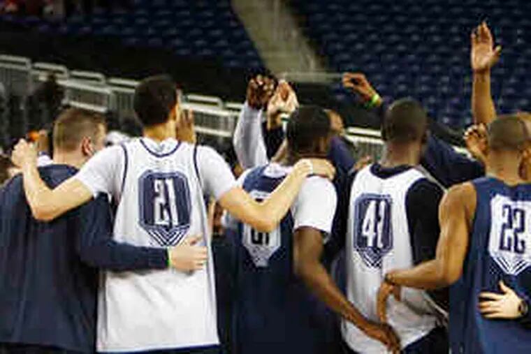 Villanova's basketball team gathers at center court after yesterday's practice at Ford Field in Detroit. &quot;Our players believe they can win,&quot; coach Jay Wright said. &quot;. . . We just have to play together.&quot;