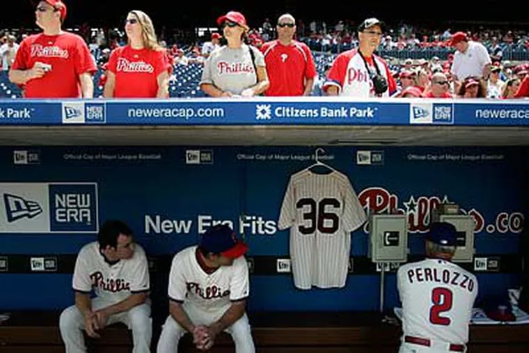 Robin Roberts' No. 36 jersey hangs in the dugout as Jamie Moyer and coach Sam Perlozzo get ready for the Cardinals. (David Swanson/Staff Photographer)