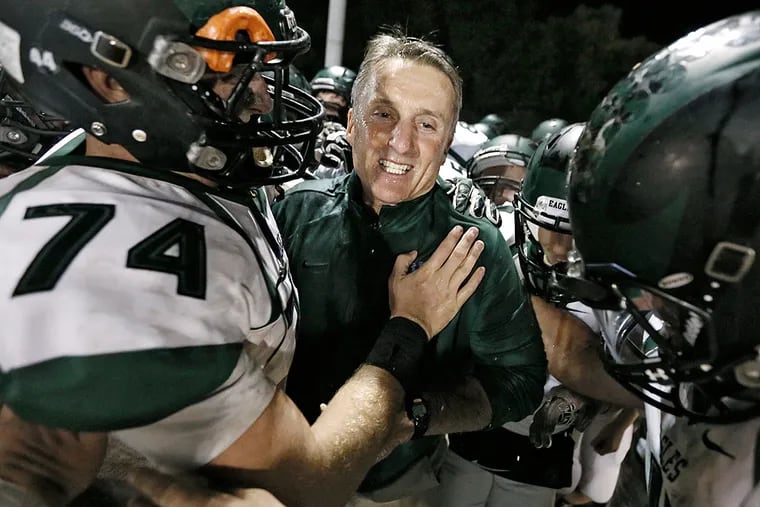 West Deptford's John Barrett hugs head coach Clyde Folsom after he got his 200th win with the Eagles.
