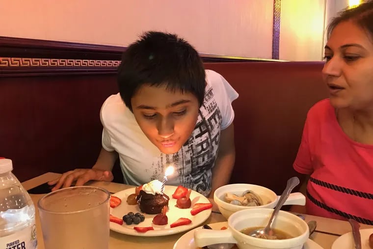 Areen Chakrabarti, shown here celebrating a recent birthday with his mother, Rumpa Banerjee, has been moved from Children's Hospital of Philadelphia, where doctors declared him brain dead, to a hospital in Guatemala.
