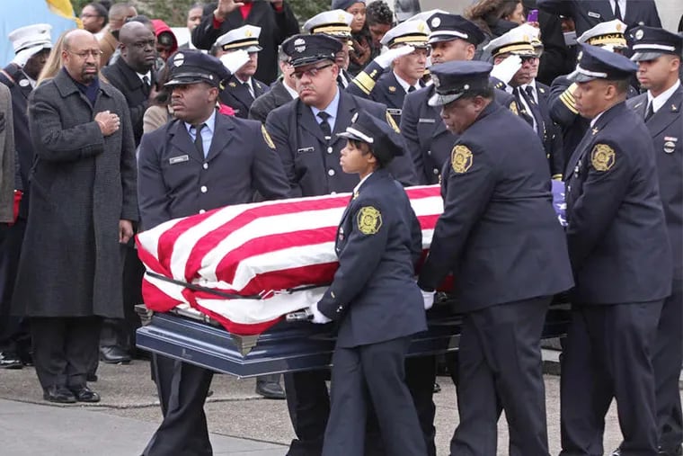 Mayor Nutter (left) salutes the casket of fallen Philly firefighter Joyce Craig with a hand over heart.