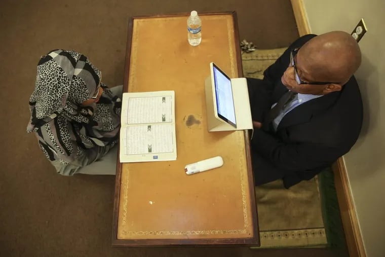 Imam Anas Muhaimin instructs student Chevonne Byas at the Quba Institute in West Philadelphia.