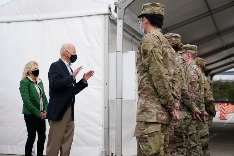 President Joe Biden and first lady Jill Biden meet with troops at a FEMA COVID-19 mass vaccination site at NRG Stadium in Houston.