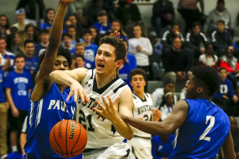 Bishop Eustace swingman Peyton Vostenak (center) gets fouled driving to the basket against Paul VI High’s Hartnel Haye (left) and Tyshon Judge during the first quarter on Thursday, January 11, 2018.