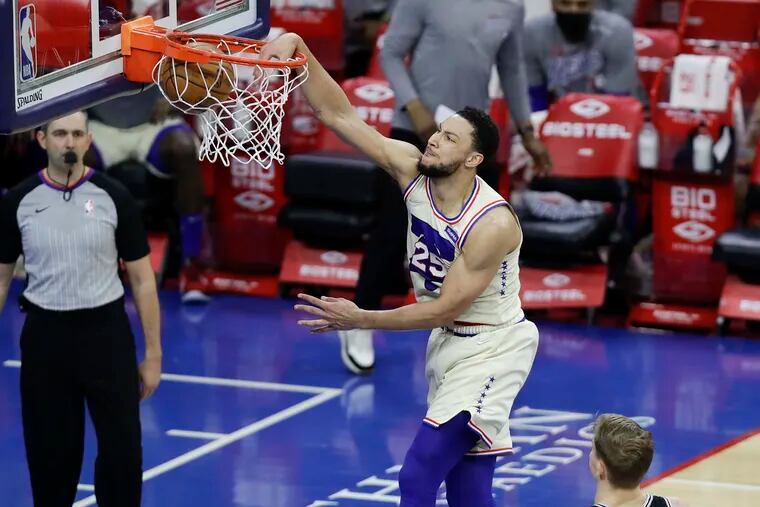 Sixers guard Ben Simmons dunks the basketball past San Antonio Spurs forward Luka Samanic in the third quarter on Sunday, March 14, 2021 in Philadelphia.