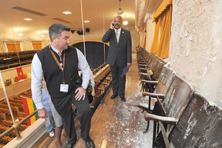 Assessing water damage in the Furness High auditorium in South Phila. are principal Tim McKenna (left) and teachers' union chief Jerry Jordan. (April Saul / Staff Photographer)