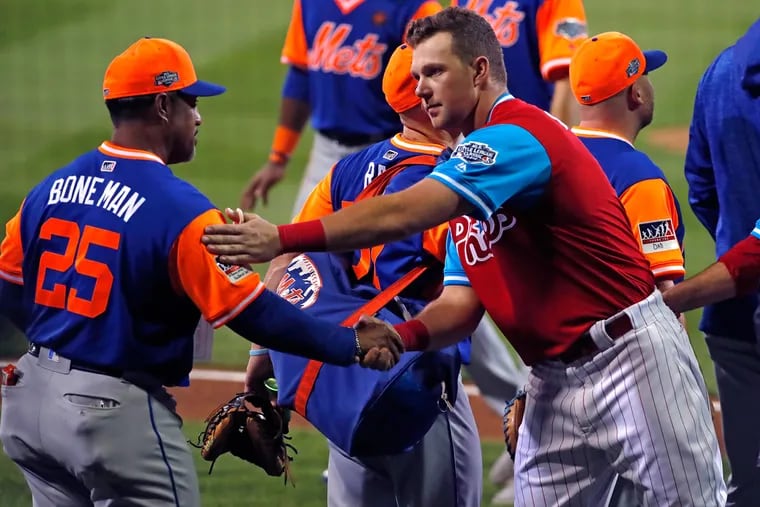 The  Phillies' Rhys Hoskins, right, shakes hands with the Mets' Ricky Bones in the handshake line after the Little League Classic on Sunday.