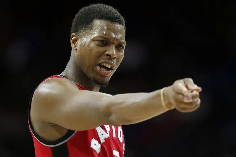 Toronto Raptors&#039; guard Kyle Lowry points against the Sixers on Wednesday, January 18, 2017 in Philadelphia.  YONG KIM / Staff Photographer