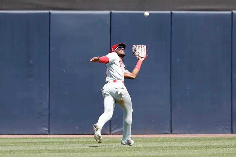 Phillies center fielder Johan Rojas run down the baseball during a spring training game against the New York Yankees at George M. Steinbrenner Field in Tampa, Fla., on Saturday.