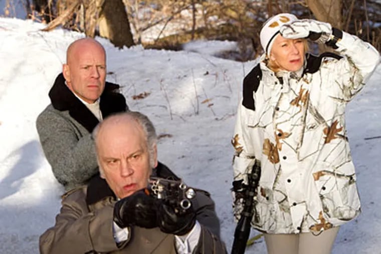 John Malkovich (foreground), Bruce Willis, and Helen Mirren in a scene from "Red." Willis plays a black-ops veteran who is retired - until someone decides to riddle his house with rounds of ammunition and artillery fire.