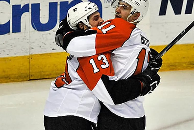 Dan Carcillo celebrated with Blair Betts after Betts scored a goal during the first period. (Steve Nesius/AP)