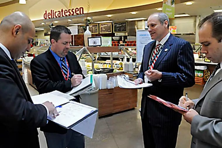Acme Markets' president Dan Sanders (2nd from RIGHT) is holding court in the Acme Super Market in the Concord Town Center in Concordville with his management team of (from left) Ajay Kanwar, VP of Merchandising; Tom Miller, Senior VP of Operations, and Don Croce, VP of Sales (right).  They were conducting a standard store tour.   ( Clem Murray / Staff Photographer )