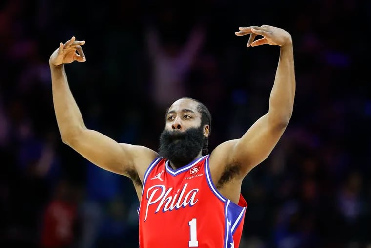 Sixers guard James Harden raises his arms after making a three-point basket during the fourth quarter against the Miami Heat in Game 4.