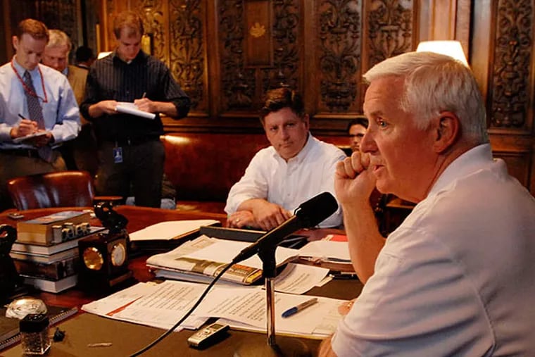 Gov. Corbett (right) and Lt. Gov. Jim Cawley discuss the state budget, which Corbett has yet to sign, at a news conference Sunday. BRADLEY C. BOWER / ASSOCIATED PRESS