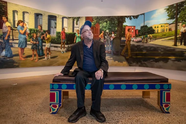 Painter Bill Scott, a friend of Edith Neff's, who died in 1995, sits at the exhibit "Our Town:  A Retrospective of Edith Neff," at the Woodmere Museum, in front of one of her largest works, a mural commissioned for the lobby of the University City Science Center in 1973.