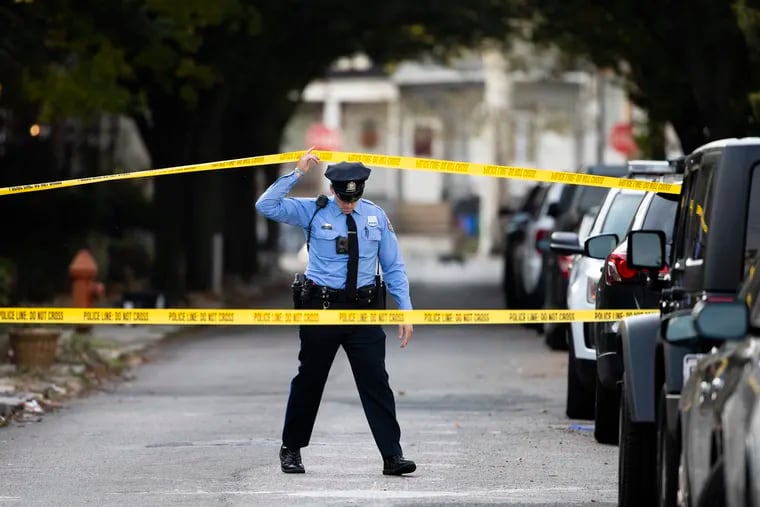 A Philadelphia Police officer enters the cordoned off scene where authorities say Nikeem Leach, 19, killed his 11-year-old brother inside their home Nov. 11.