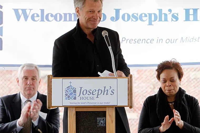Jon Bon Jovi finishes his remarks at the opening ceremony for Camden's new homeless shelter, Joseph’s House, on April 1, 2014. Left is Executive Dir. of Joseph’s House, John Klein. Camden Mayor Dana Redd sits to his right. ( AKIRA SUWA  /  Staff Photographer )