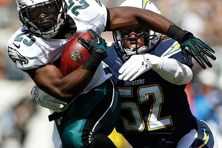 Eagles' LeSean McCoy, left, is chased down by the Chargers' Reggie
Walker, right, during the first quarter. (David Maialetti/Staff Photographer)