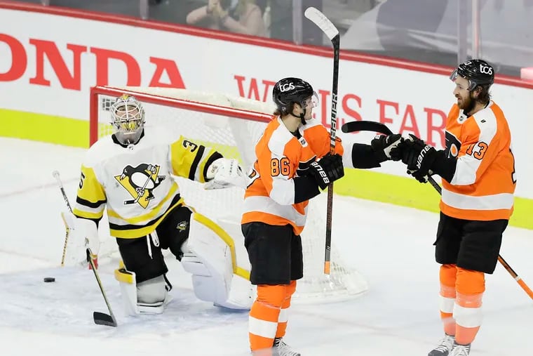 Flyers right wing Joel Farabee (center) celebrates his second-period goal with teammate center Kevin Hayes past Pittsburgh Penguins goaltender Tristan Jarry.