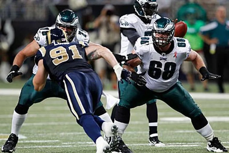 Eagles offensive linemen Todd Herremans (left) and Evan Mathis block for Michael Vick against the Rams. (Yong Kim/Staff Photographer)
