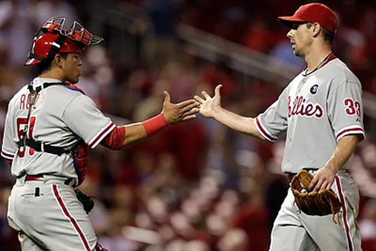 Cliff Lee and Carlos Ruiz celebrate after the final out of the Phillies' win. (Jeff Roberson/AP)