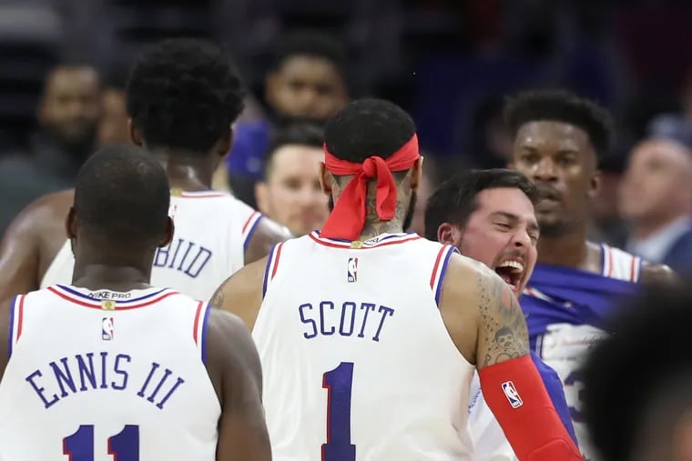 The Sixers bench, including TJ McConnell, center, celebrates after a Mike Scott 3-point shot against the Raptors during the 3rd quarter of their NBA Eastern Conference Semifinal Playoff Game at the Wells Fargo Center on May 9, 2019.