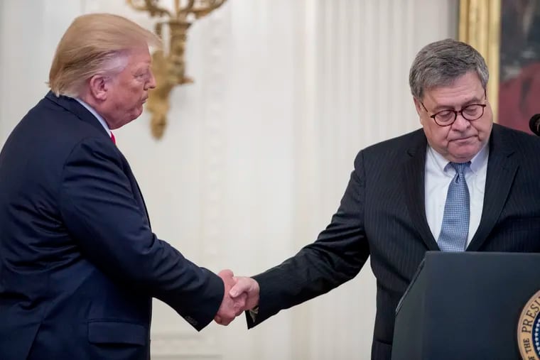 President Donald Trump (left) shakes hands with Attorney General William Barr (right) at an event in September.