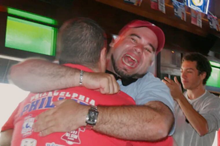 Phillies fans share the joy at Chickie & Pete&#0039;s in South Philadelphia after the team clinched the National League East.
