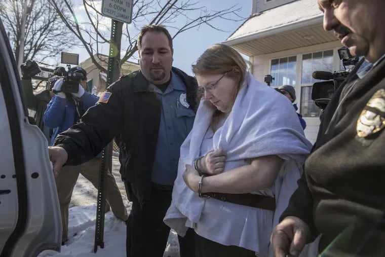 Sara Packer, the adoptive mother of rape-murder victim Grace Packer, with handcuffs on her wrists, is put into a Pennsylvania Constable vehicle after her arraignment at District Court in Newtown, PA on Sunday, Jan. 8, 2016.
