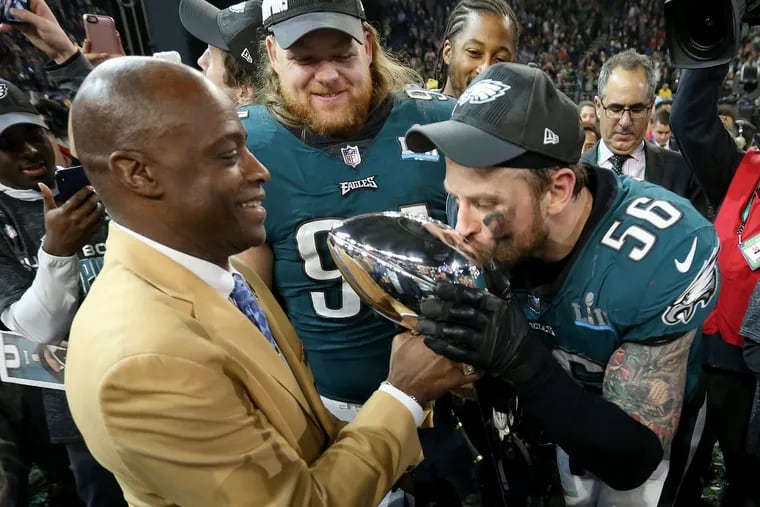 This Feb. 4 image shows Eagles defensive end Chris Long kissing the Lombardi trophy. The team's White House invitation was rescinded by President Trump on Monday. TIM TAI / Staff Photographer 