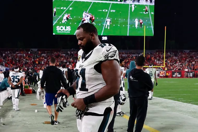 Eagles defensive tackle Fletcher Cox walks the sideline late in his final game, the playoff loss to the Tampa Bay Buccaneers on Jan. 15.