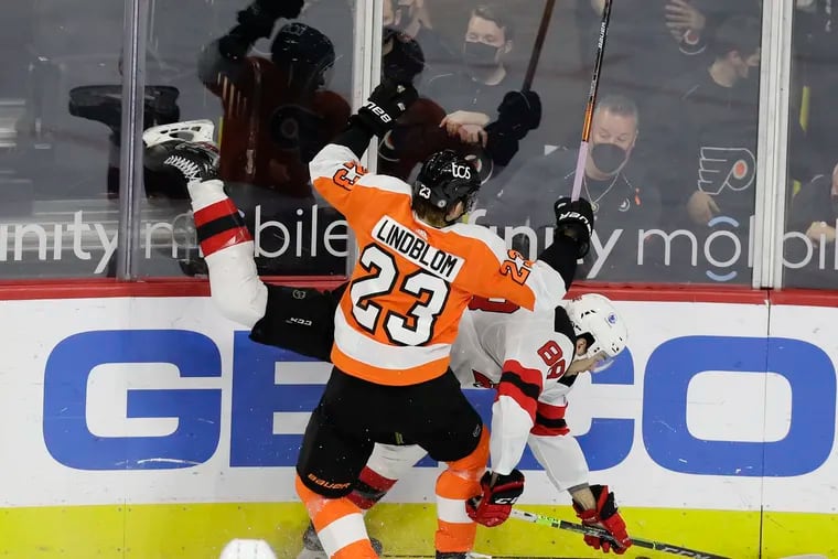 Flyers left winger Oskar Lindblom checks New Jersey Devils defenseman Kevin Bahl in the teams' season finale on May 10.