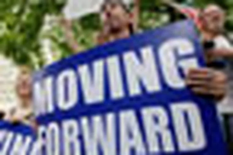 People hold signs during a rally at Daley Plaza in Chicago on Thursday, June 28, 2012. In a dramatic victory for President Barack Obama, the Supreme Court upheld the 2010 health care law Thursday, preserving Obama’s landmark legislative achievement. (AP Photo/ Nam Y. Huh)