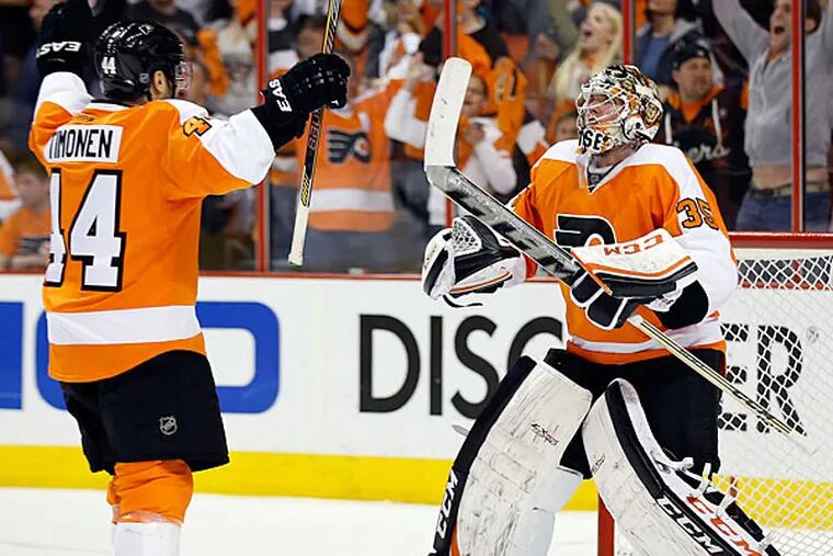 Steve Mason celebrates the Flyers win over the Rangers with teammate Kimmo Timonen. (Yong Kim/Staff Photographer)
