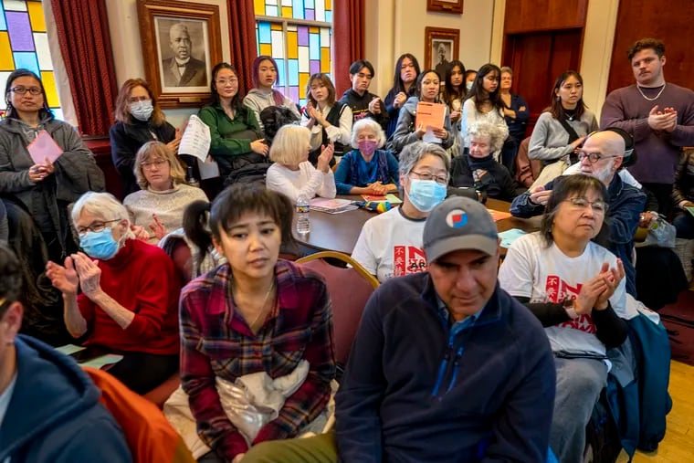 Ellen Somekawa (left) and Debbie Wei (right, both in white “No Arena” T-shirts, in second row) with Asian Americans United, attend a community meeting  at Mother Bethel A.M.E. Church on the impact of the Sixers' proposed arena. Councilmember Mark Squilla and numerous clergy members hosted the meeting.