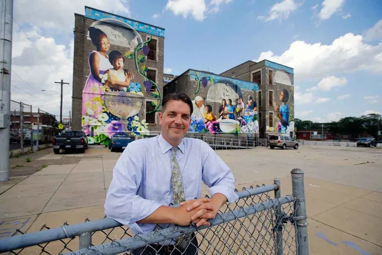 St. Malachy’s principal, Stephen Janczewski, outside the school’s new location, whose mural was signed by Pope Francis. The grant from the Philadelphia School Partnership will allow improvements.