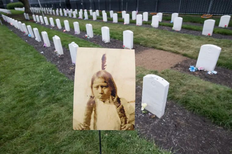 The grave of Little Plume/Hayes Vanderbilt Friday is now unknown.  Two Northern Arapaho children were disinterred from the Carlisle Barracks Indian Cemetery, but two bodies were found in the grave of Little Plume, but neither was a biological match. Unknown remains are now buried in the grassless spot in the background. Historical photo of Little Plume courtesy of the Carlisle Indian School Digital Resource Center at Dickinson College.  CHARLES FOX / Staff Photographer