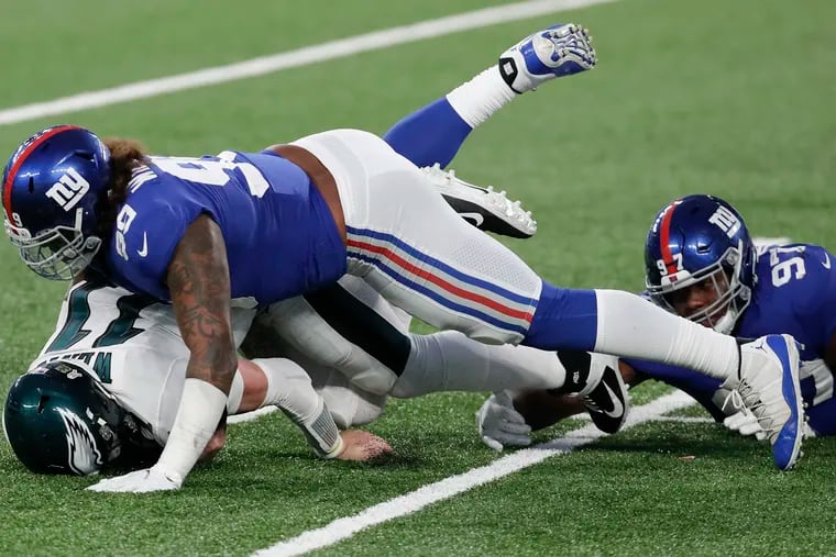 Eagles QB Carson Wentz gets sacked by New York Giants DE Leonard Williams in the fourth quarter of Sunday's 27-17 loss.