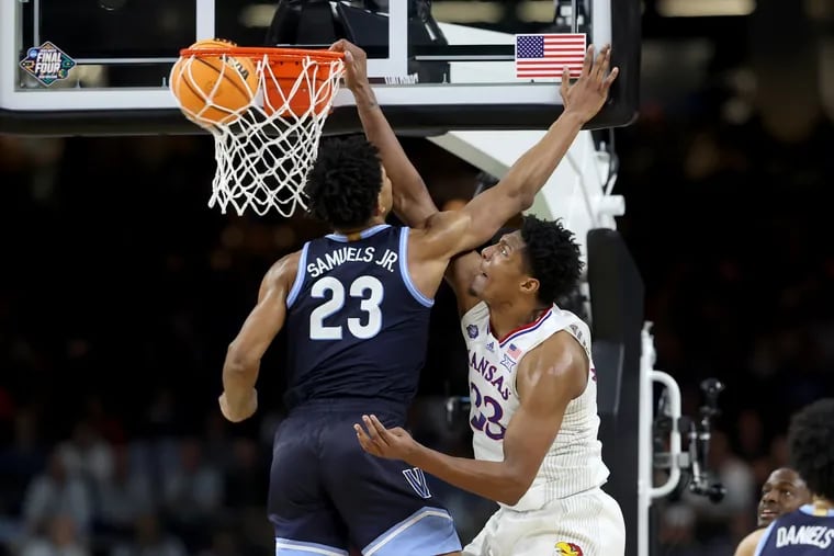 David McCormack, right, of Kansas dunks over Jermaine Samuels during the 2nd half of their national semifinal game of the NCAA Tournament on  April 2, 2022 at the Superdome in New Orleans.