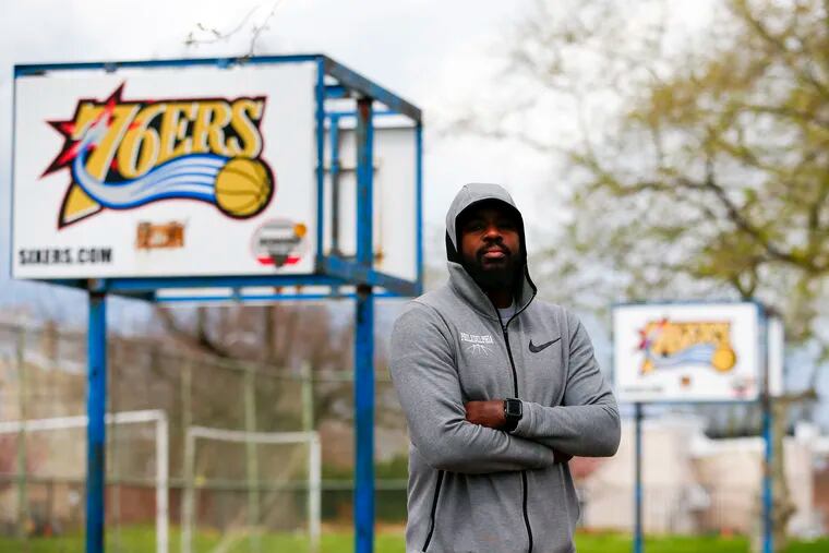 Andre Wright stands at the Athletic Recreation Center in North Philadelphia with basket-less basketball backboards on Thursday, April 9 2020.  The COVID-19 outbreak has Wright and so many other youth-sports officials trying to stay connected to athletes through phone calls, text messages and social media platforms but feel the frustration of not being able to get these kids together for sports activities.