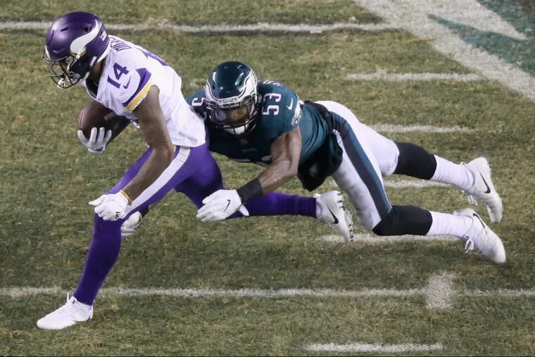 Eagles linebacker Nigel Bradham (right) tackles Vikings wide receiver Stefon Diggs during the second half of the NFC championship game on Sunday.