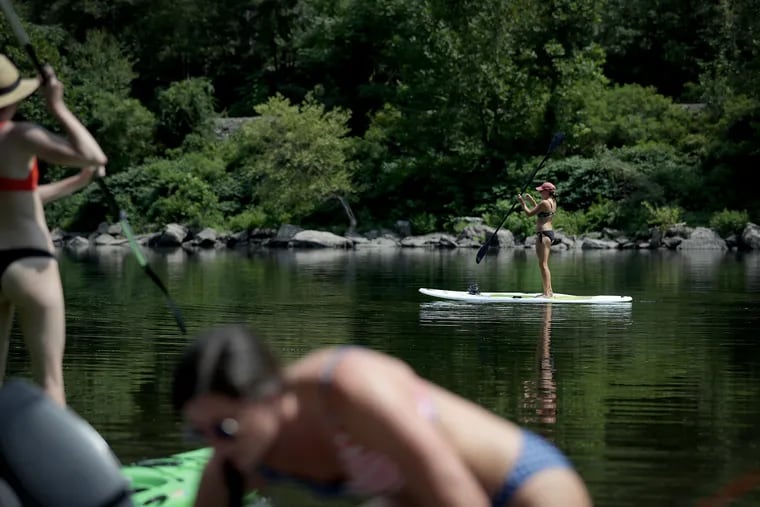 Julie Gallagher, background, of Flanders, NJ, paddles the Delaware River with her friends in the Delaware Water Gap on August 1, 2019.