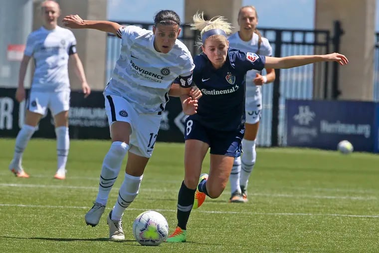 Portland Thorns forward Christine Sinclair (12) and North Carolina Courage midfielder Denise O'Sullivan (8) battle for the ball during the second half of the teams' matchup in the NWSL Challenge Cup first round on June 27. They meet again in the quarterfinals on Friday.