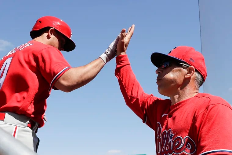 The Phillies' Scott Kingery celebrates his a two-run home run with manager Joe Girardi in the win against the Boston Red Sox in Fort Myers, Fla.