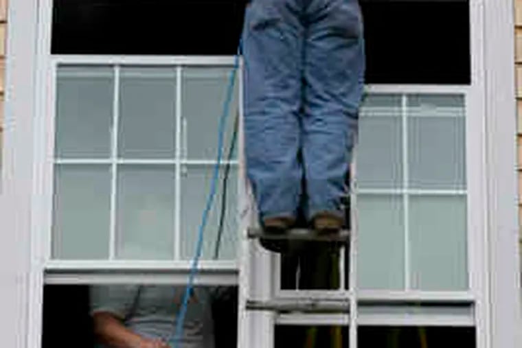 Workers install ducts in a new home in Burlington, Mass. New construction rose last month, a Commerce Dept. report said.