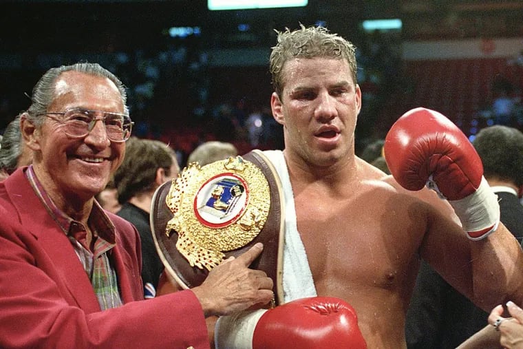 In this June 7, 1993 file photo, newly crowned WBO heavyweight champion Tommy Morrison receives his championship belt after defeating George Foreman in Las Vegas, Nev. ()