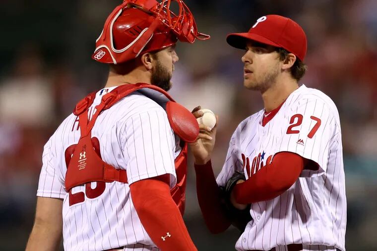Phils catcher Cameron Rupp visiting with Aaron Nola in the fourth. &quot;He relies on command, and if he doesn't have his command, he's vulnerable,&quot; manager Pete Mackanin said of Nola. Associated Press