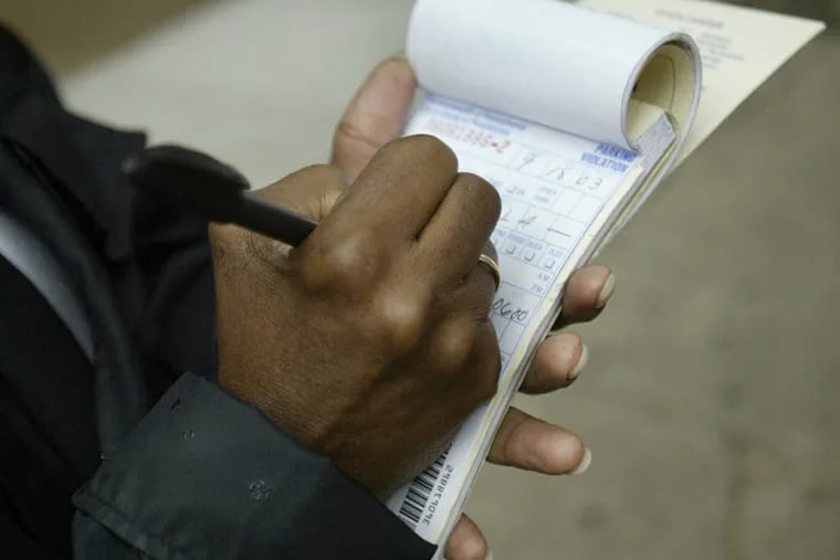 A Parking Authority employee writes tickets on Walnut Street in Philadelphia.