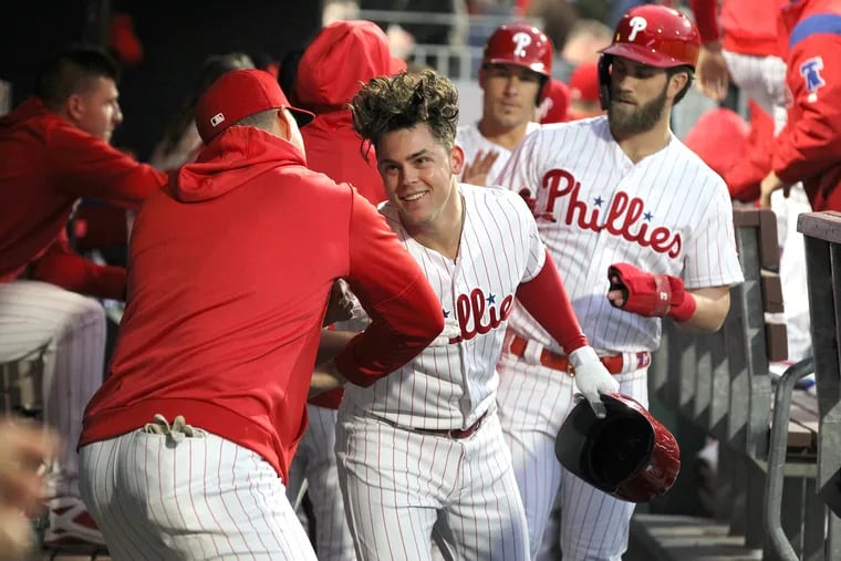 Scott Kingery, center, of the Phillies  is congratulated in the dugout after hitting a 3-run home run off of Steven Matz of the Mets in the 1st inning at Citizens Bank Park on April 16, 2019.